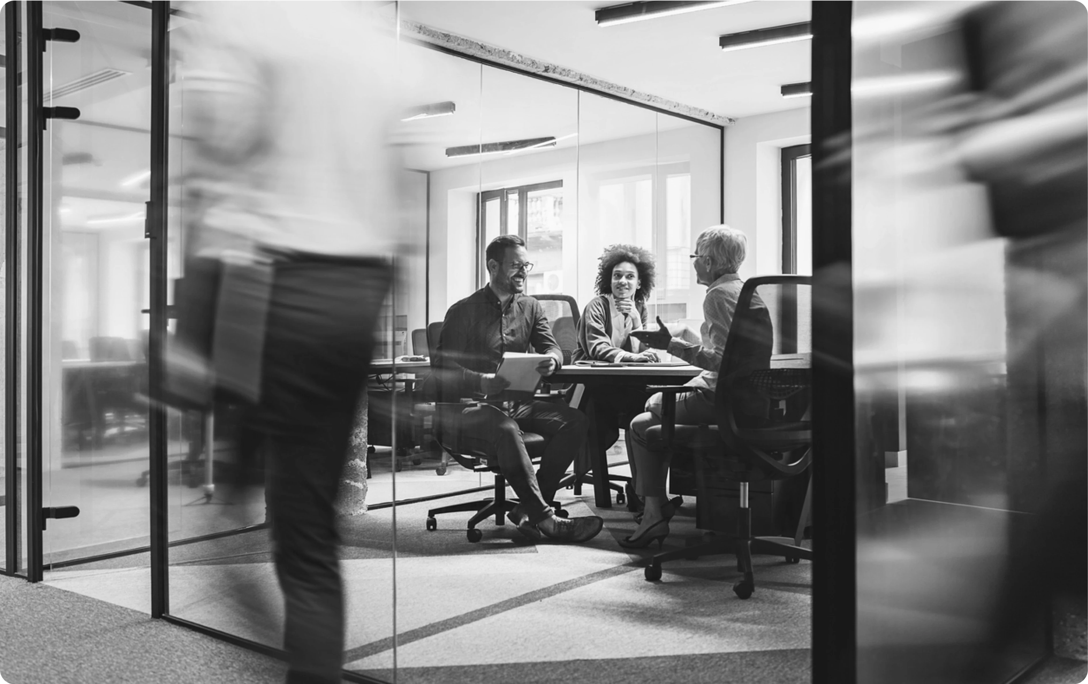 Cybersecurity professionals in a meeting room discussing OutThink's human risk management platform's streamlined workflows.